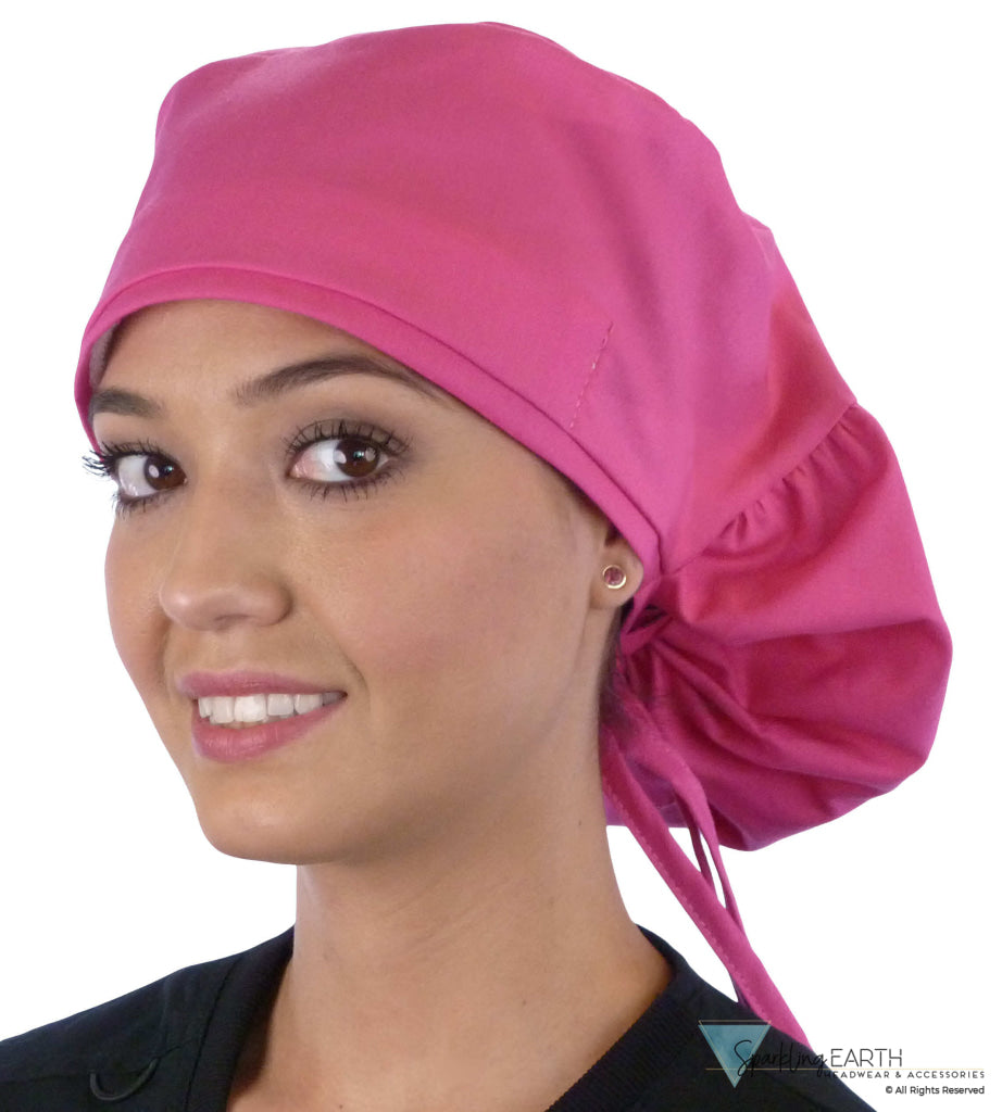 Front facing untied image of a woman in scrubs wearing a Hot Pink Big Hair Ponytail Scrub Cap and hot pink ties to hold the scrub cap in place.