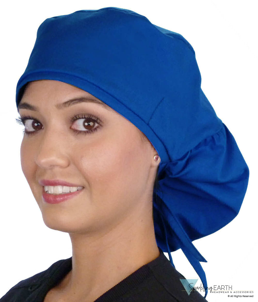 Front facing untied image of a woman in scrubs wearing a Royal Big Hair Ponytail Scrub Cap and royal ties to hold the scrub cap in place.