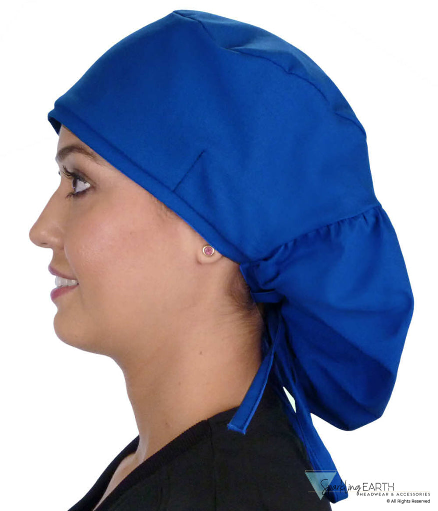 Side facing untied image of a woman in scrubs wearing a Royal Big Hair Ponytail Scrub Cap and royal ties to hold the scrub cap in place.