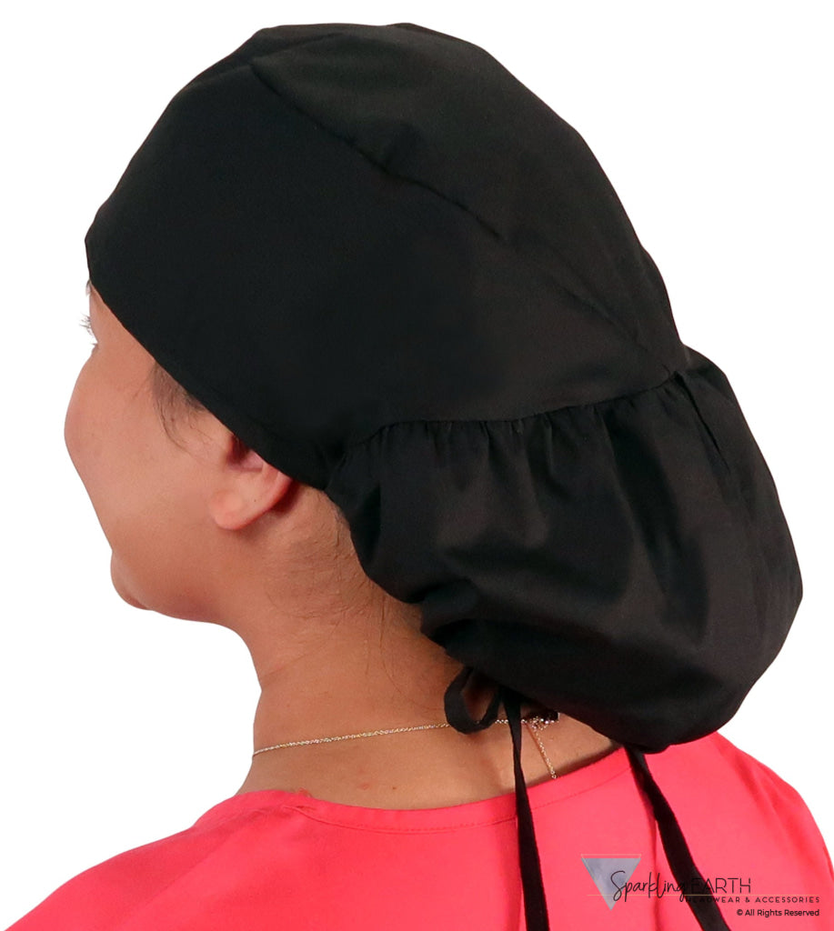Side untied facing image of a woman in scrubs wearing a Black Big Hair Ponytail Scrub Cap and black ties to hold the scrub cap in place.