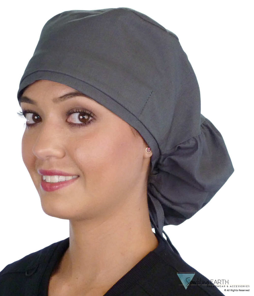 Side facing untied image of a woman in scrubs wearing a Grey Big Hair Ponytail Scrub Cap and grey ties to hold the scrub cap in place.