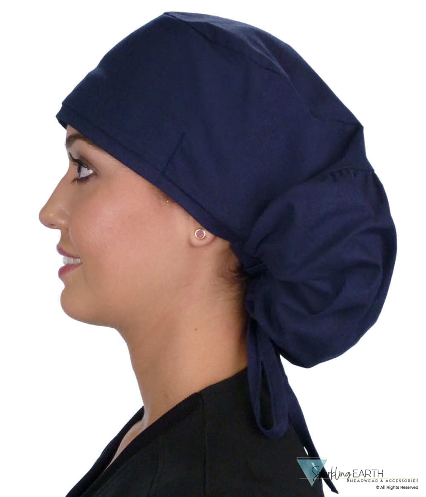 Side facing untied image of a woman in scrubs wearing a Navy Big Hair Ponytail Scrub Cap and navy ties to hold the scrub cap in place.