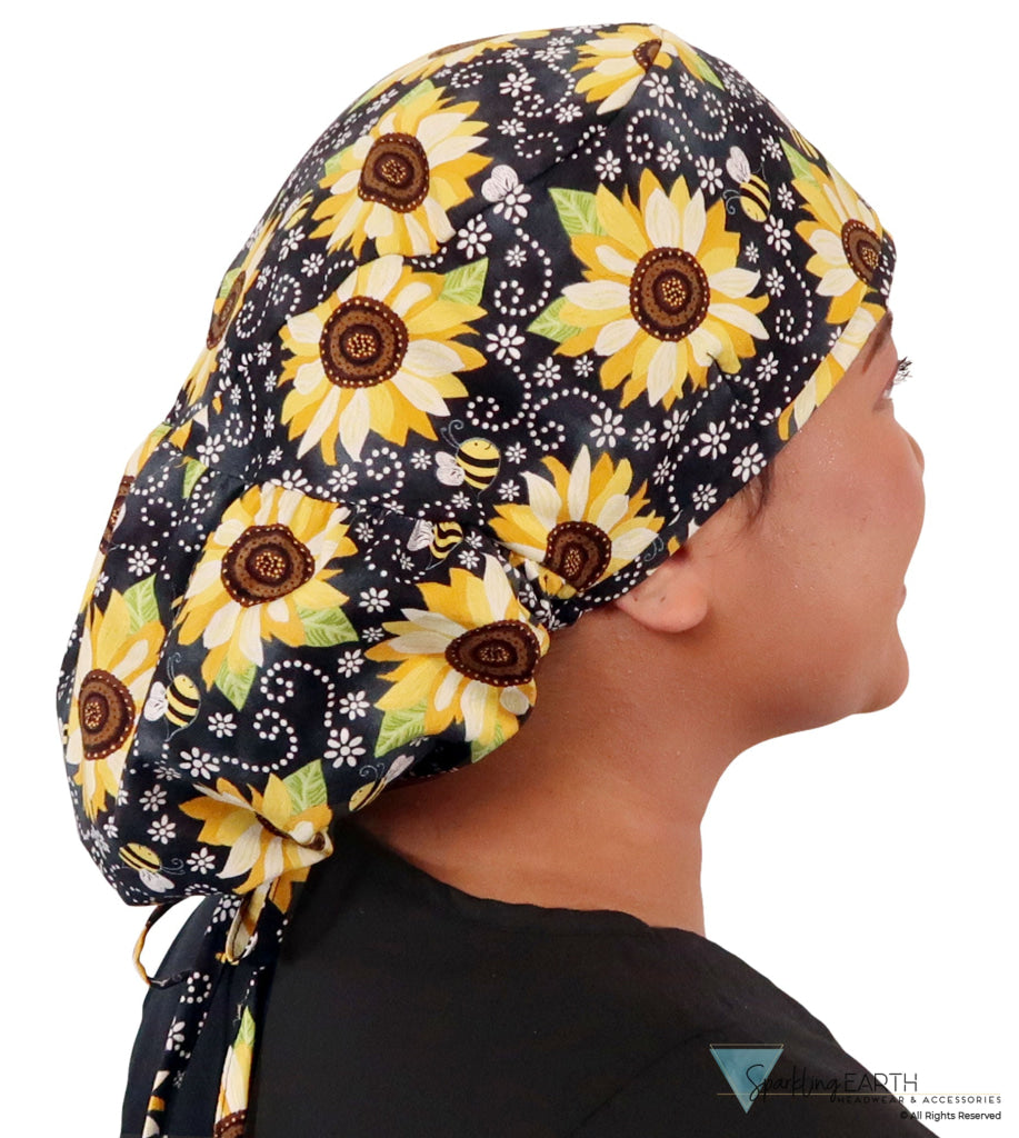 Side facing untied image of a woman in scrubs wearing a Big Hair Ponytail Scrub Cap with a Sunflowers on Black pattern.