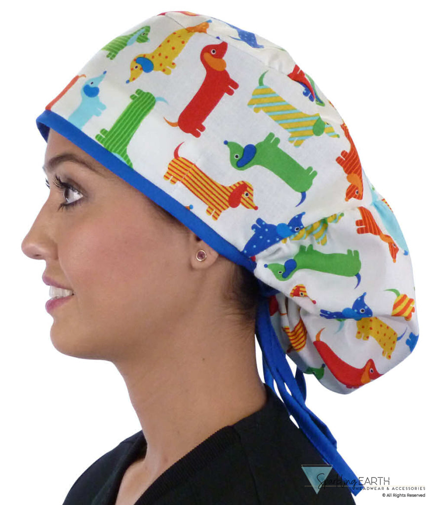 Side facing untied image of a woman in scrubs wearing a Big Hair Ponytail Scrub Cap with a Tossed Wiener Dogs pattern, and royal ties to hold the scrub cap in place.