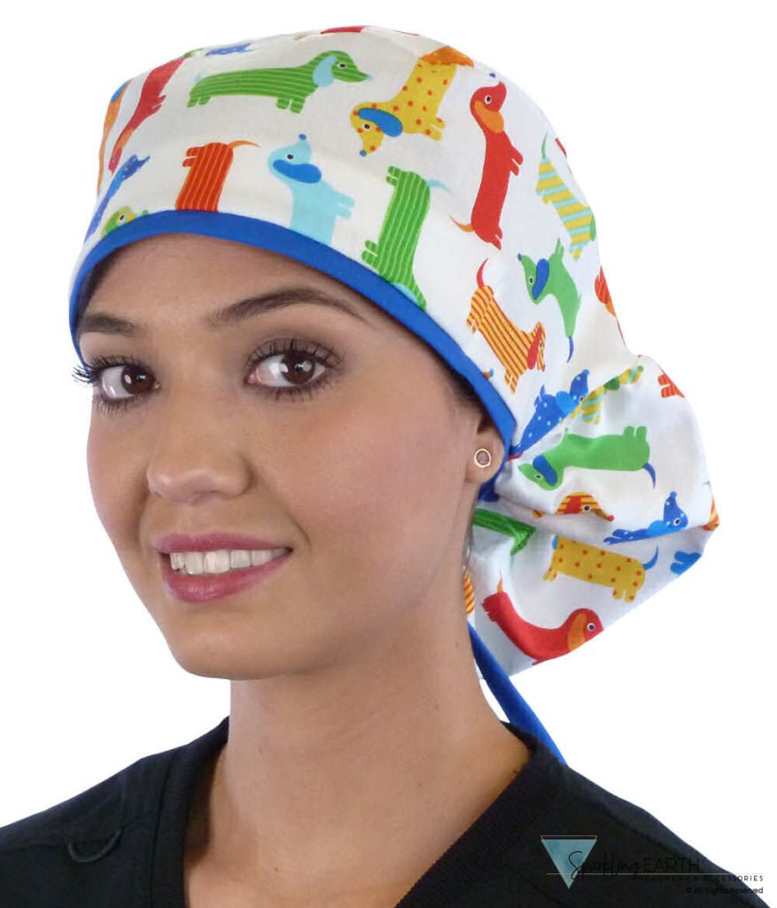 Front facing untied image of a woman in scrubs wearing a Big Hair Ponytail Scrub Cap with a Tossed Wiener Dogs pattern, and royal ties to hold the scrub cap in place.
