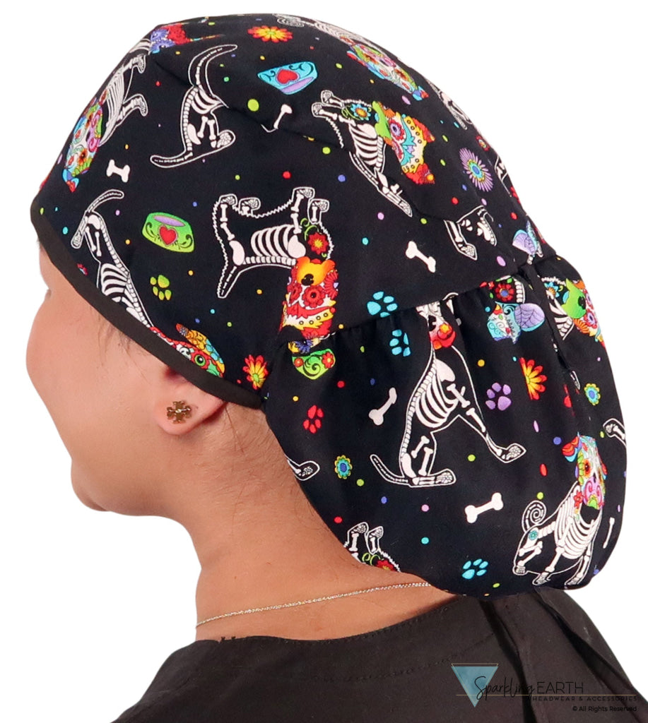Side facing untied image of a woman in scrubs wearing a Big Hair Ponytail Scrub Cap with a X-Ray Dogs pattern, and black ties to hold the scrub cap in place.