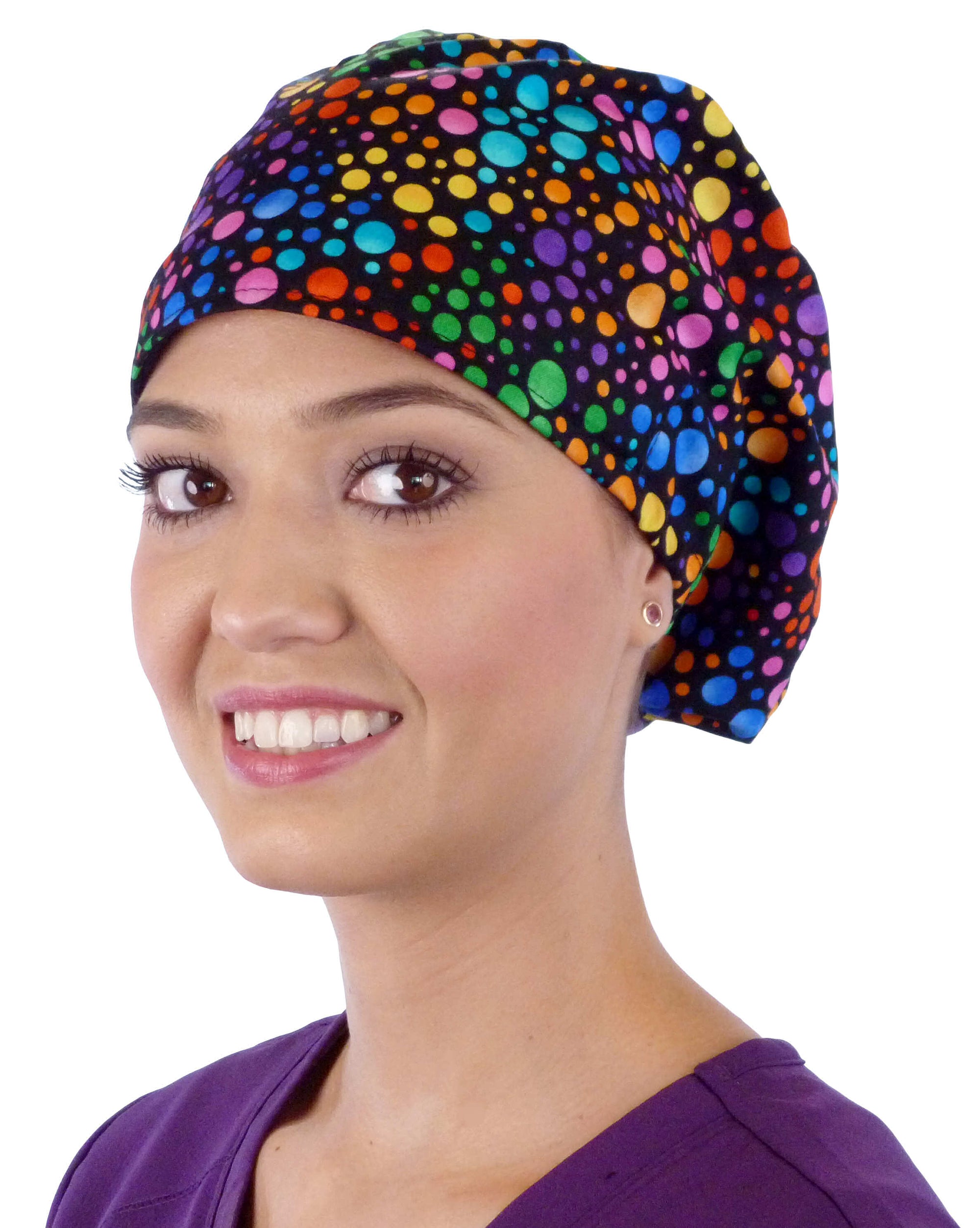 Front facing image of a woman in scrubs wearing a Multi Colored Dots Euro Style Riley Comfort Scrub Cap.