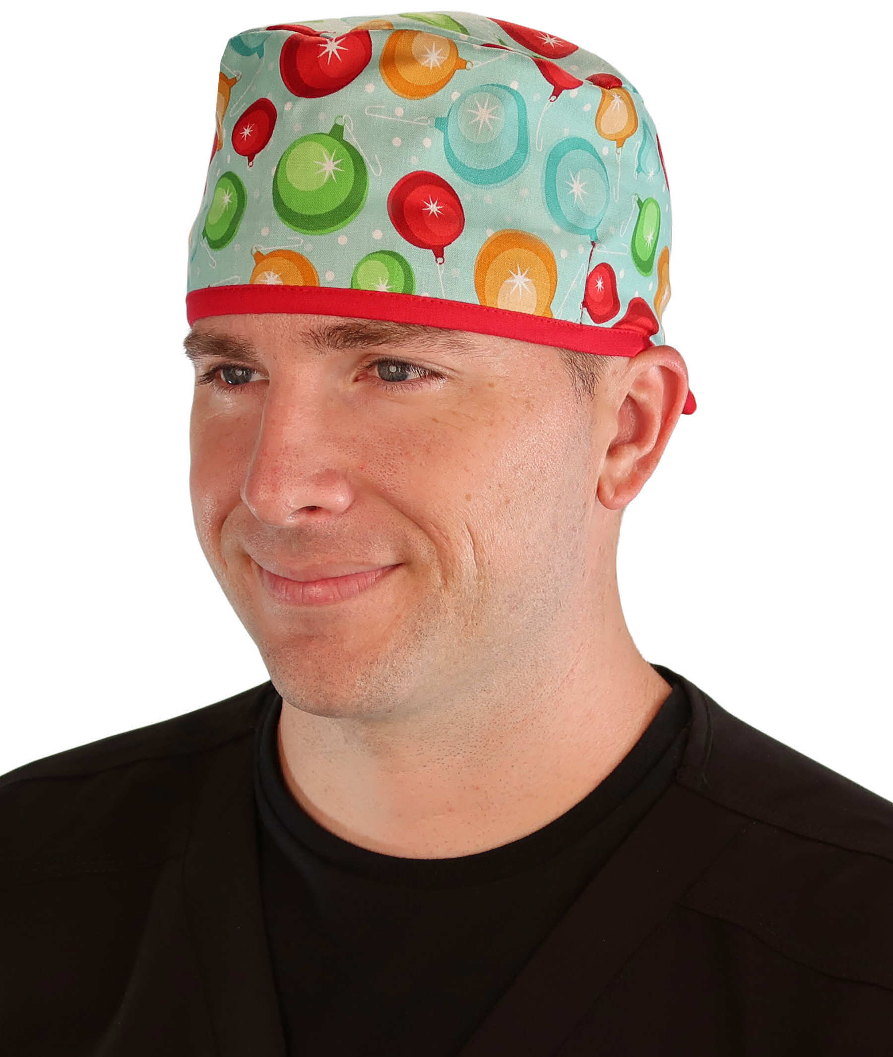 Front facing image of a man in scrubs wearing a Classic Surgical Scrub Cap with a Christmas Ornaments with Red Ties pattern.