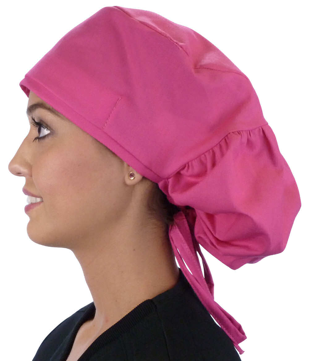 Side facing untied image of a woman in scrubs wearing a Hot Pink Big Hair Ponytail Scrub Cap and hot pink ties to hold the scrub cap in place.