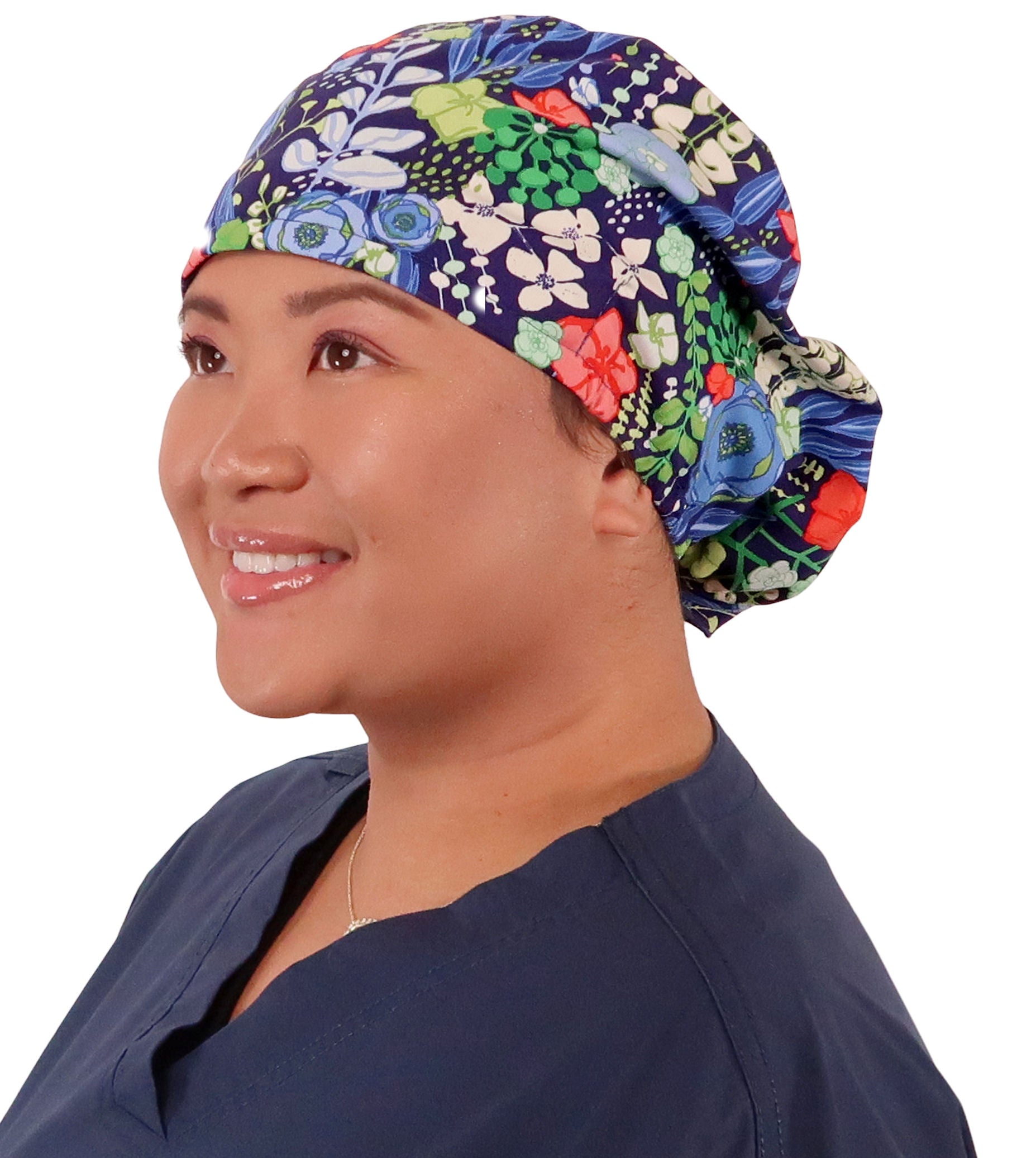 Front facing image of a woman in scrubs wearing a Flowing Blue Florals Euro Style Riley Comfort Scrub Cap.