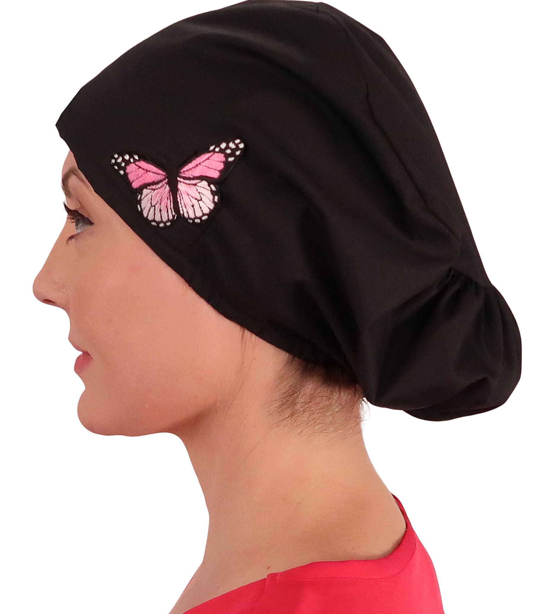 Side facing image of a woman in scrubs wearing a Pink Butterfly Patch on Black Euro Style Riley Comfort Scrub Cap.