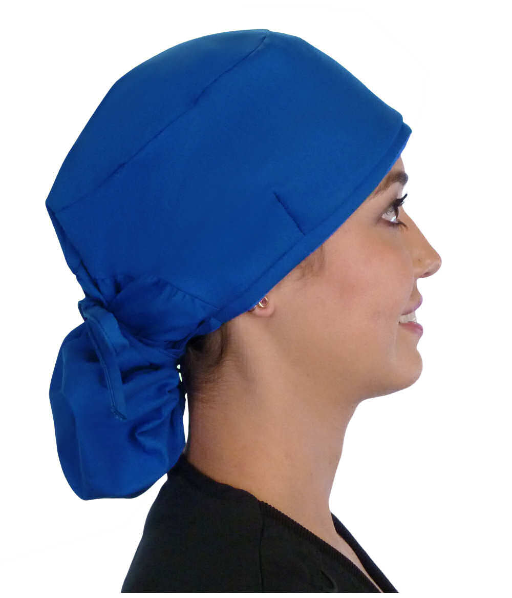 Side facing tied image of a woman in scrubs wearing a Royal Big Hair Ponytail Scrub Cap and royal ties to hold the scrub cap in place.