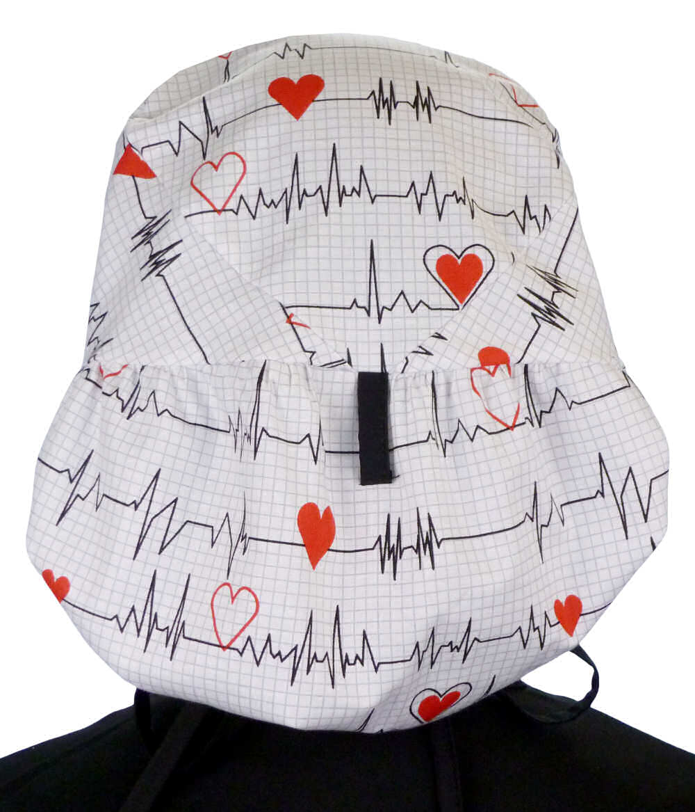 Back facing untied image of a woman in scrubs wearing a Big Hair Ponytail Scrub Cap with a Heartbeats on White pattern, and black ties to hold the scrub cap in place.