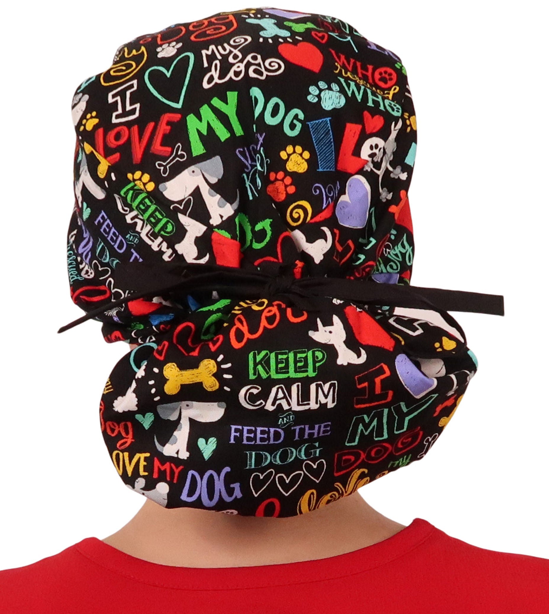 Back facing tied image of a woman in scrubs wearing a Big Hair Ponytail Scrub Cap with a I Love My Dog pattern, and black ties to hold the scrub cap in place