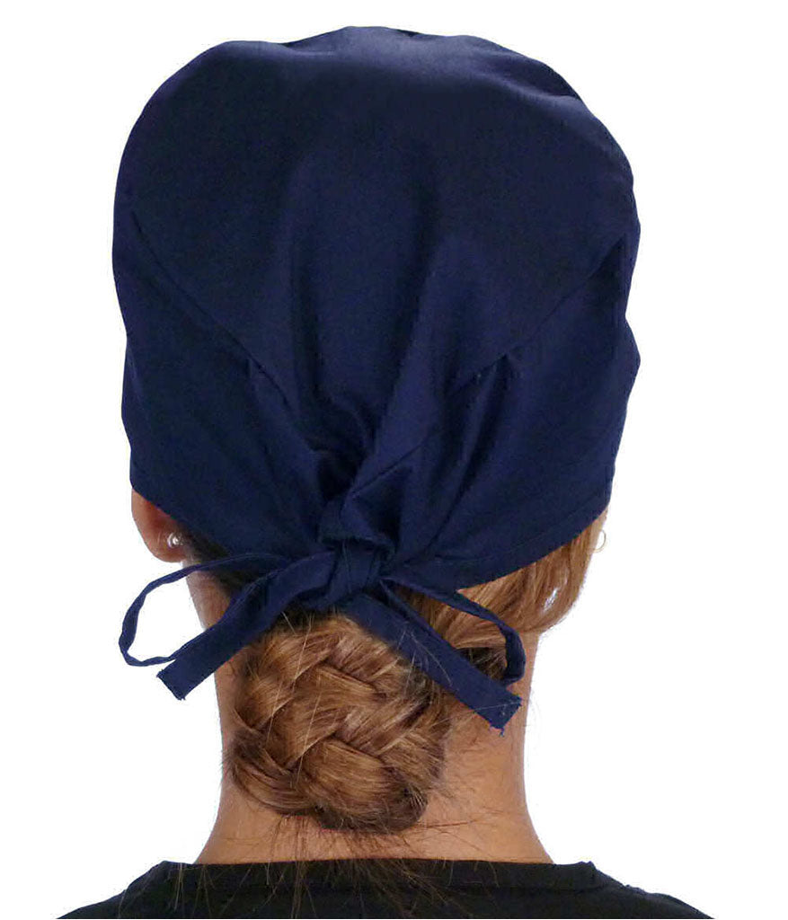 Back Facing View of a Woman Wearing a Classic Cotton Surgical Scrub Cap - Navy Fabric with Medical Heart Patch.