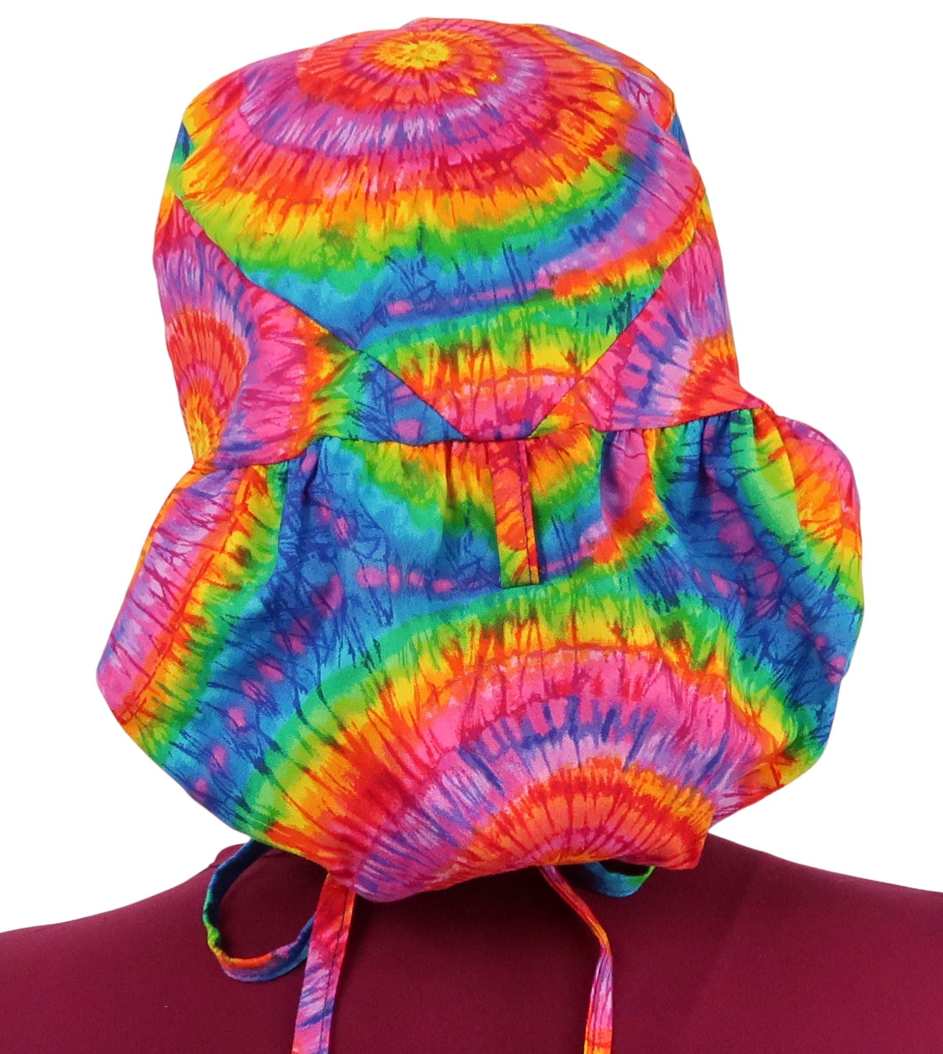 Back facing image untied of a woman in scrubs wearing a Big Hair Ponytail Scrub Cap with a Tie Dye pattern.