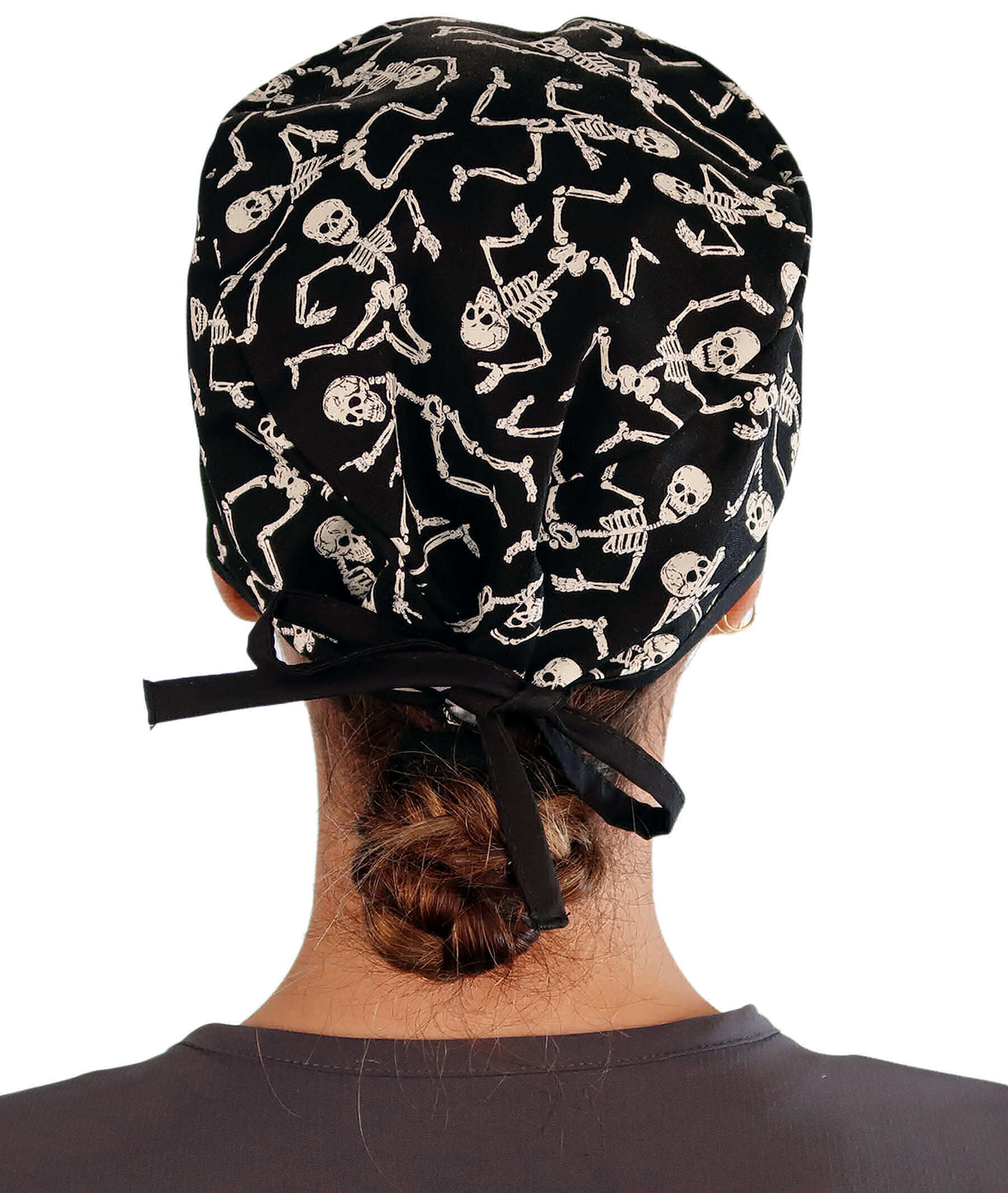 Back Facing View of a Woman Wearing a Classic Cotton Surgical Scrub Cap - Dancing Skeletons with Black Ties (Glow In The Dark) Pattern.