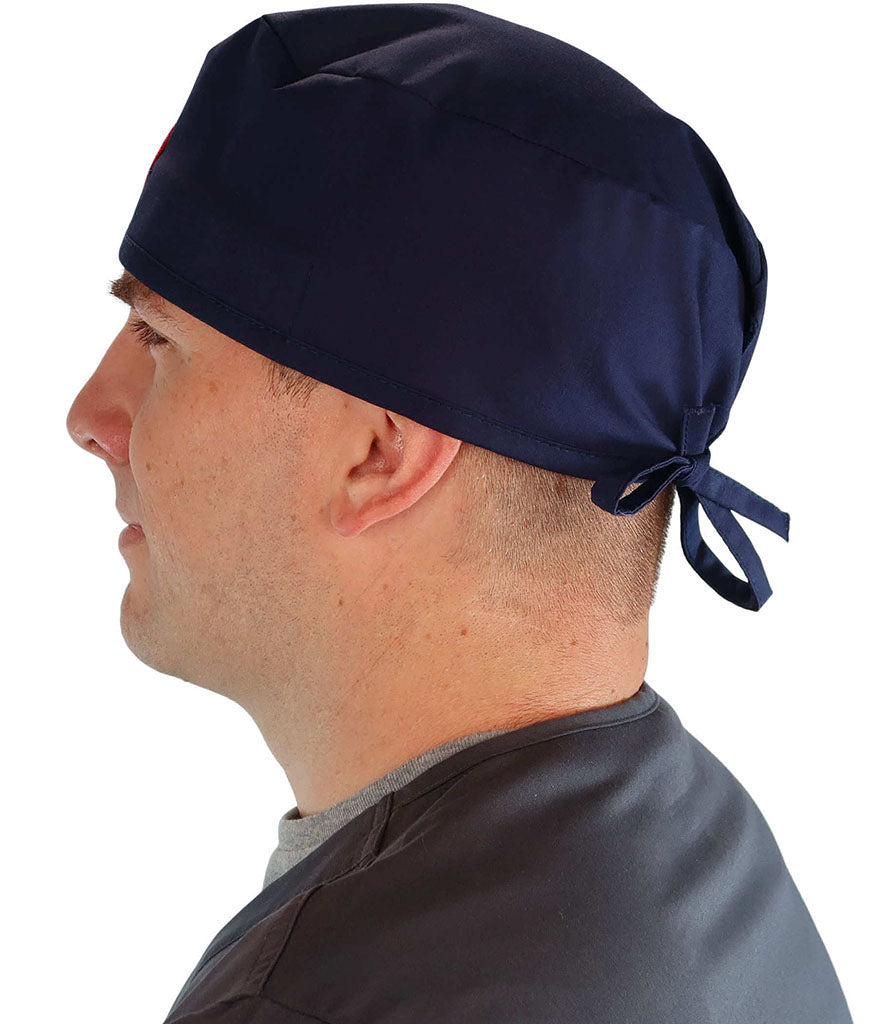Side Facing View of a Man Wearing a Classic Cotton Surgical Scrub Cap - Navy Fabric with Medical Heart Patch.