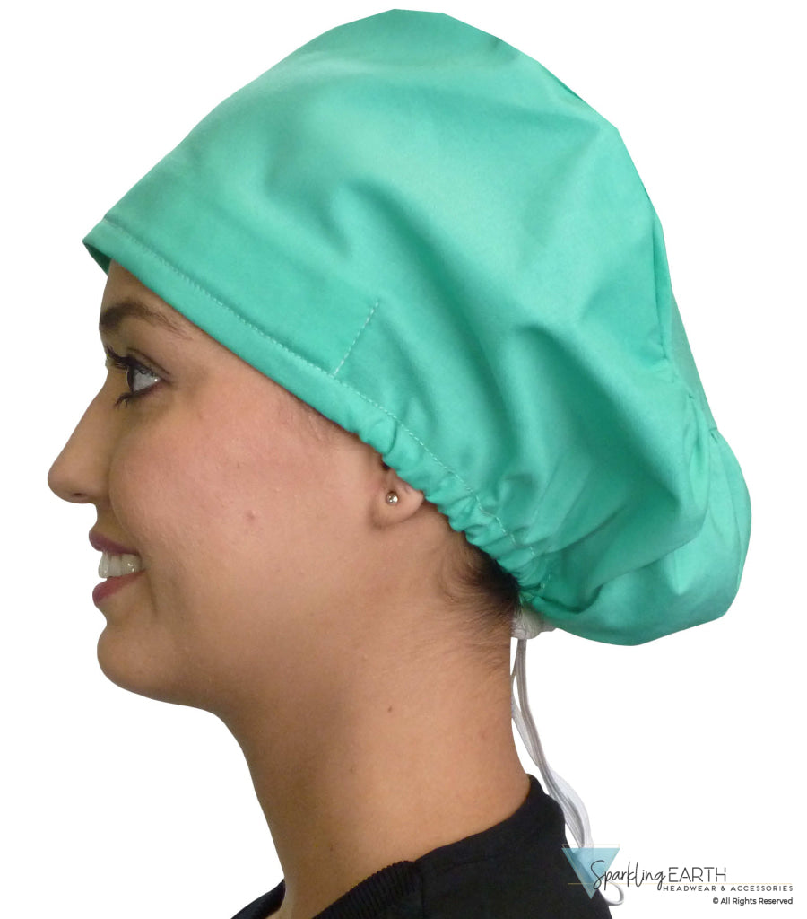 Side facing image of a woman in scrubs wearing a Scrub Green Euro Style Riley Comfort Scrub Cap.