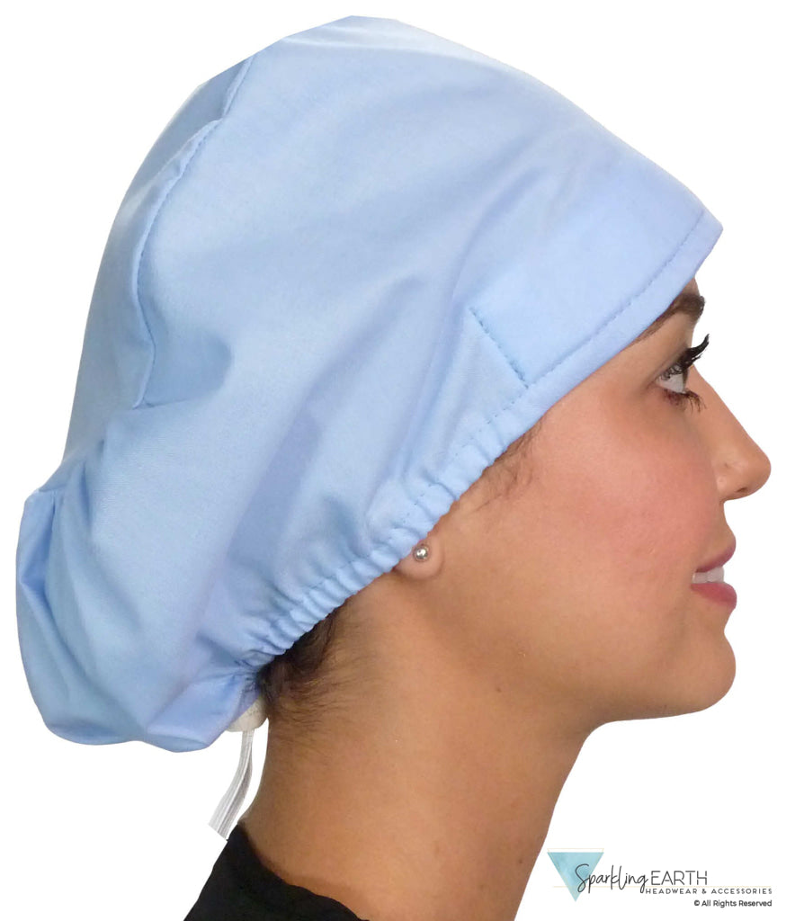 Side facing image of a woman in scrubs wearing a Light Sky Blue Euro Style Riley Comfort Scrub Cap.