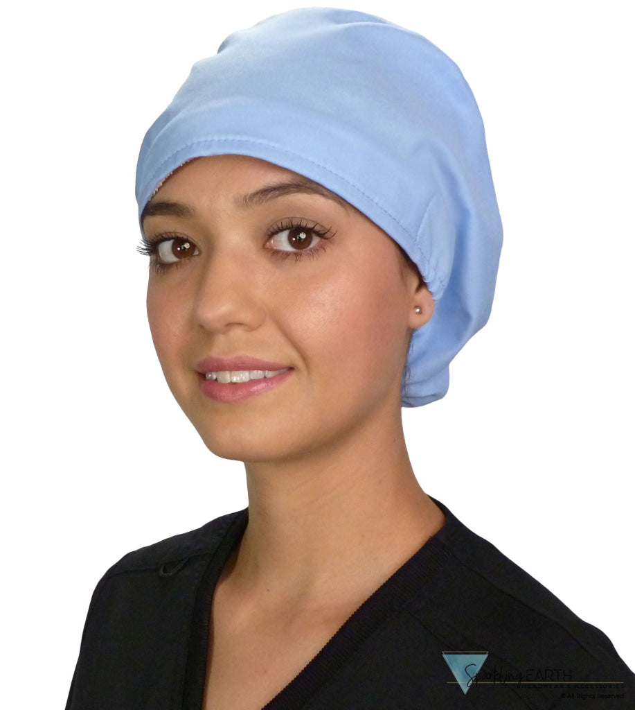 Front facing image of a woman in scrubs wearing a Light Sky Blue Euro Style Riley Comfort Scrub Cap.