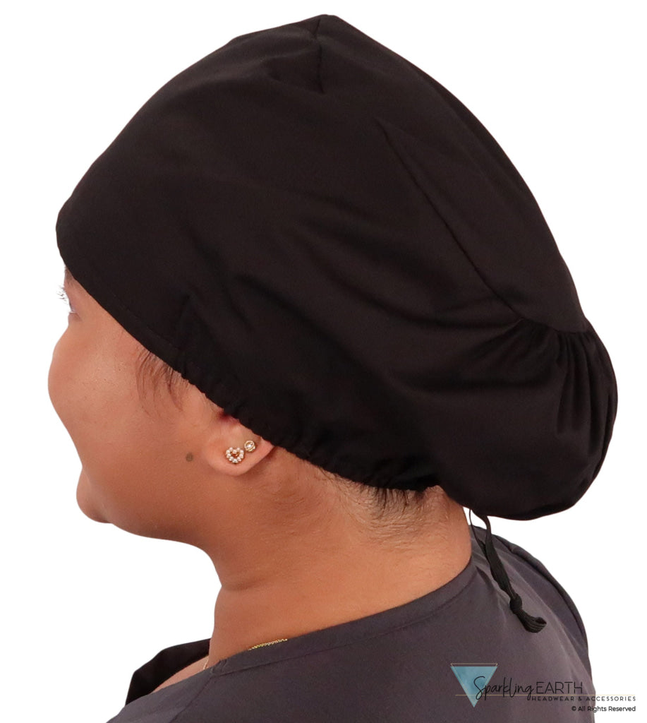 Side facing image of a woman in scrubs wearing a Black Euro Style Riley Comfort Scrub Cap.