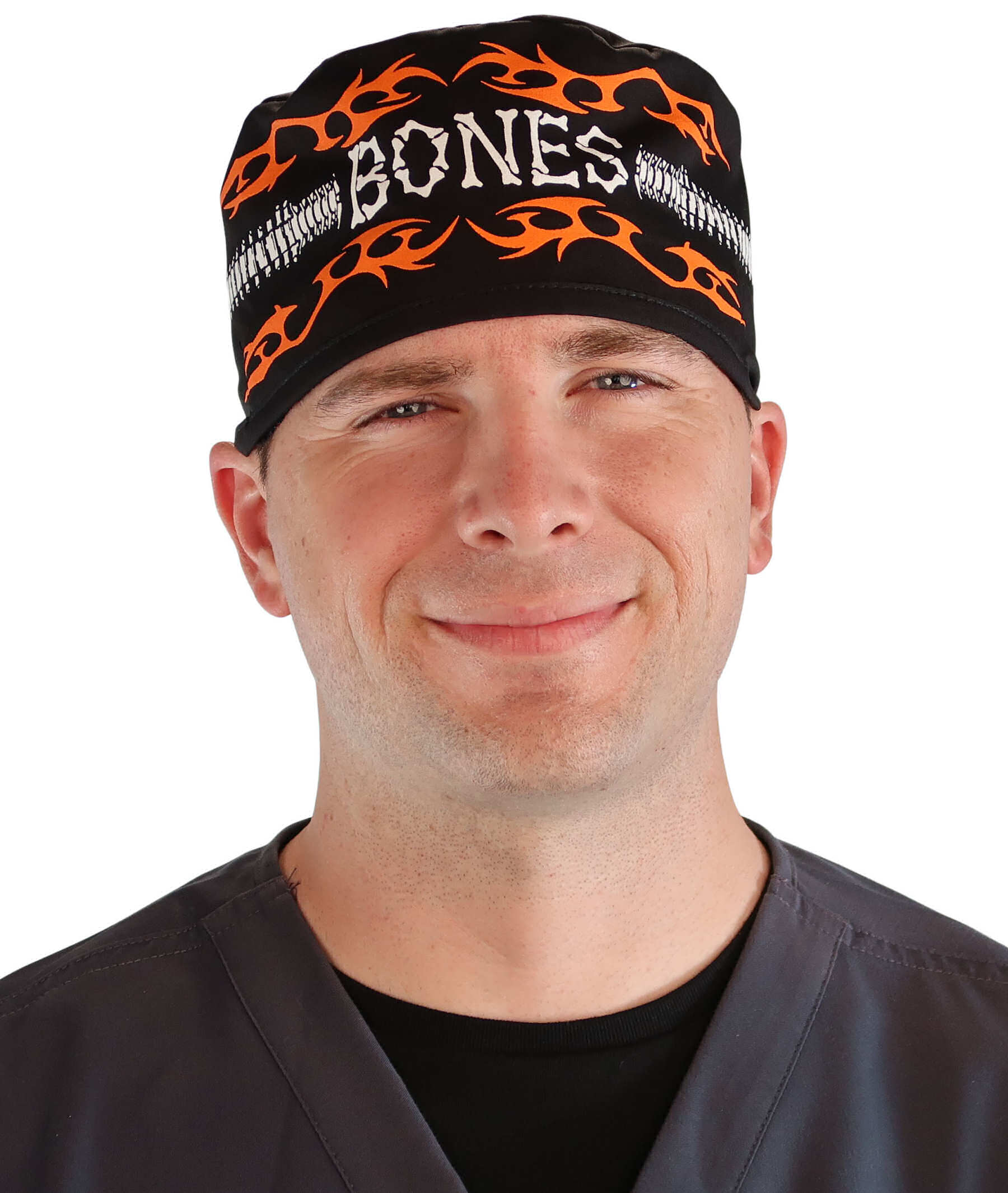 Front facing image of a man in scrubs wearing a Classic Surgical Scrub Cap in a Bones on Black pattern.